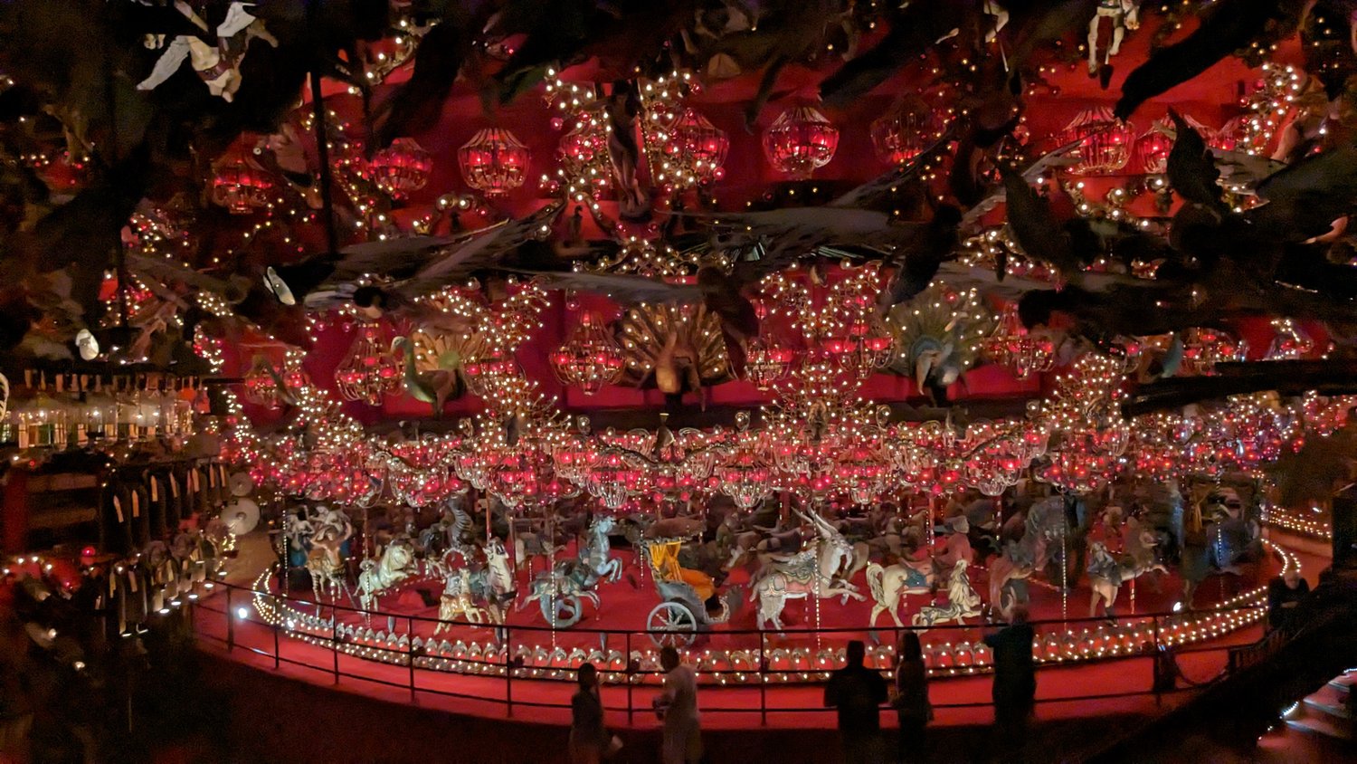 a large, red, indoor carousel with over 100 animals