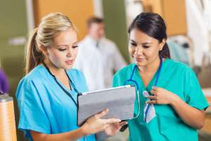 Nurses consulting about patient chart with digital tablet in hospital