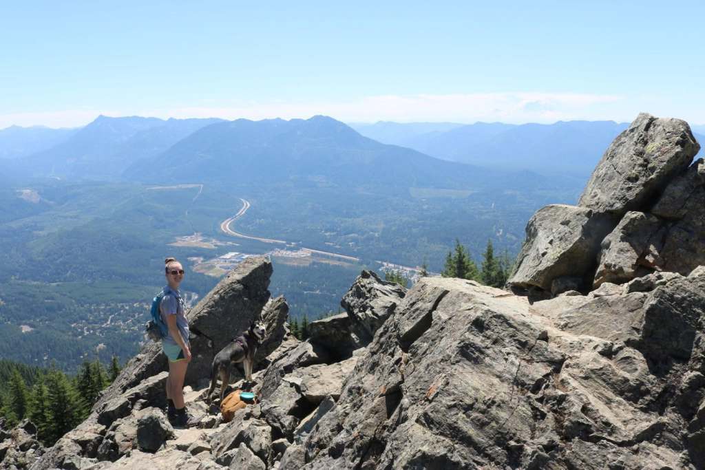 travel nurse with her dog on a trail in the pacific northwest