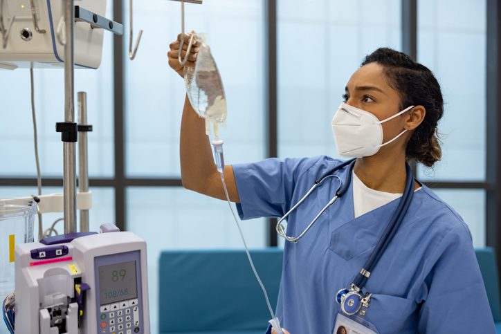 January Healthcare Awareness Days Recognized in the U.S. African American nurse at the hospital putting an IV Drip on a patient - healthcare and medicine concepts
