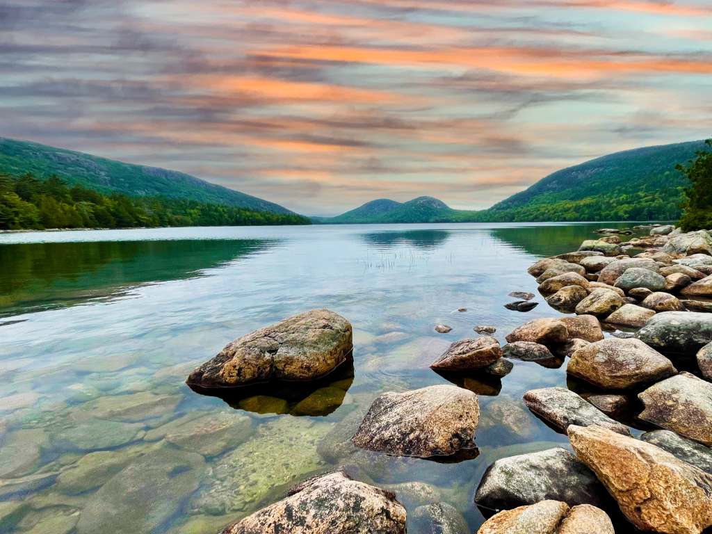 Where to Enjoy the Great Outdoors as a Healthcare Traveler Clear waters of Jordan Pond with views of the Bubbles mountains in Acadia National Park, Maine on a sunny day