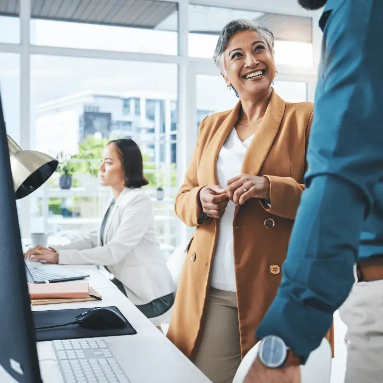Non-clinical healthcare professionals collaborating in a bright, modern office environment.