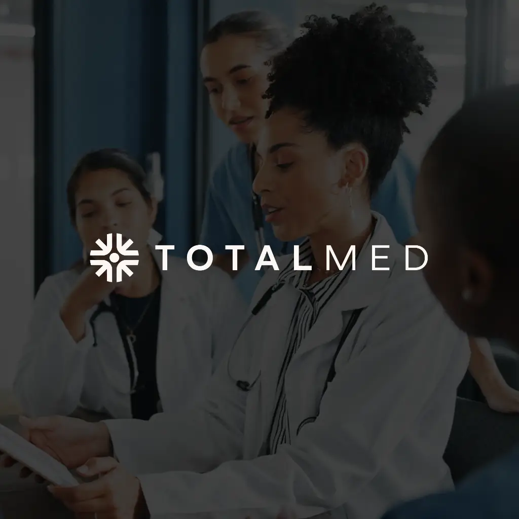TotalMed logo with healthcare workers in background looking at screen