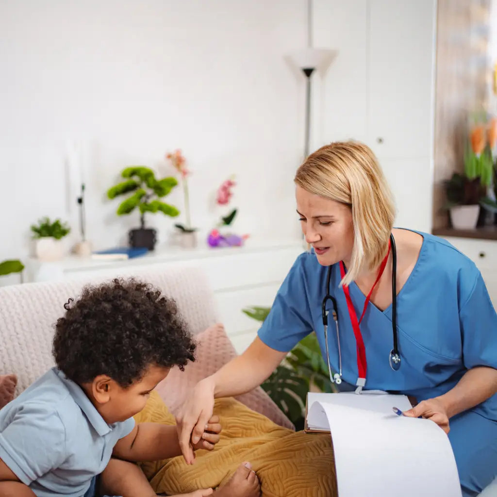 Female nurse tending to toddler patient